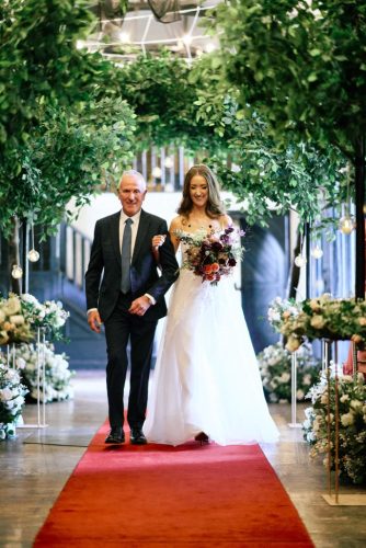 bride-walks-red-carpet-with-father