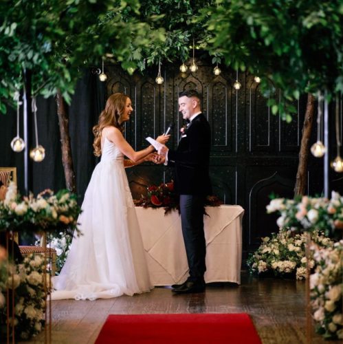 couple-exchanges-vows-under-indoor-trees